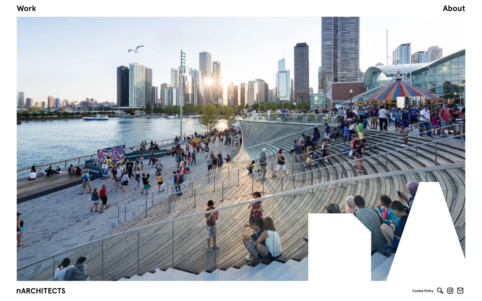 narchitects.com, architect website design: a wide photograph of a crowded waterfront pier with a city skyline behind it