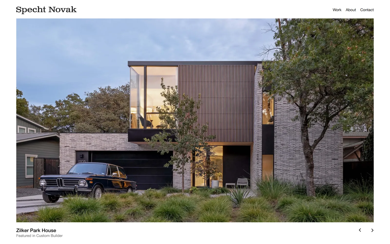 spechtnovak.com, architect website design: a two-storey brick and timber house at dusk fills most of the page