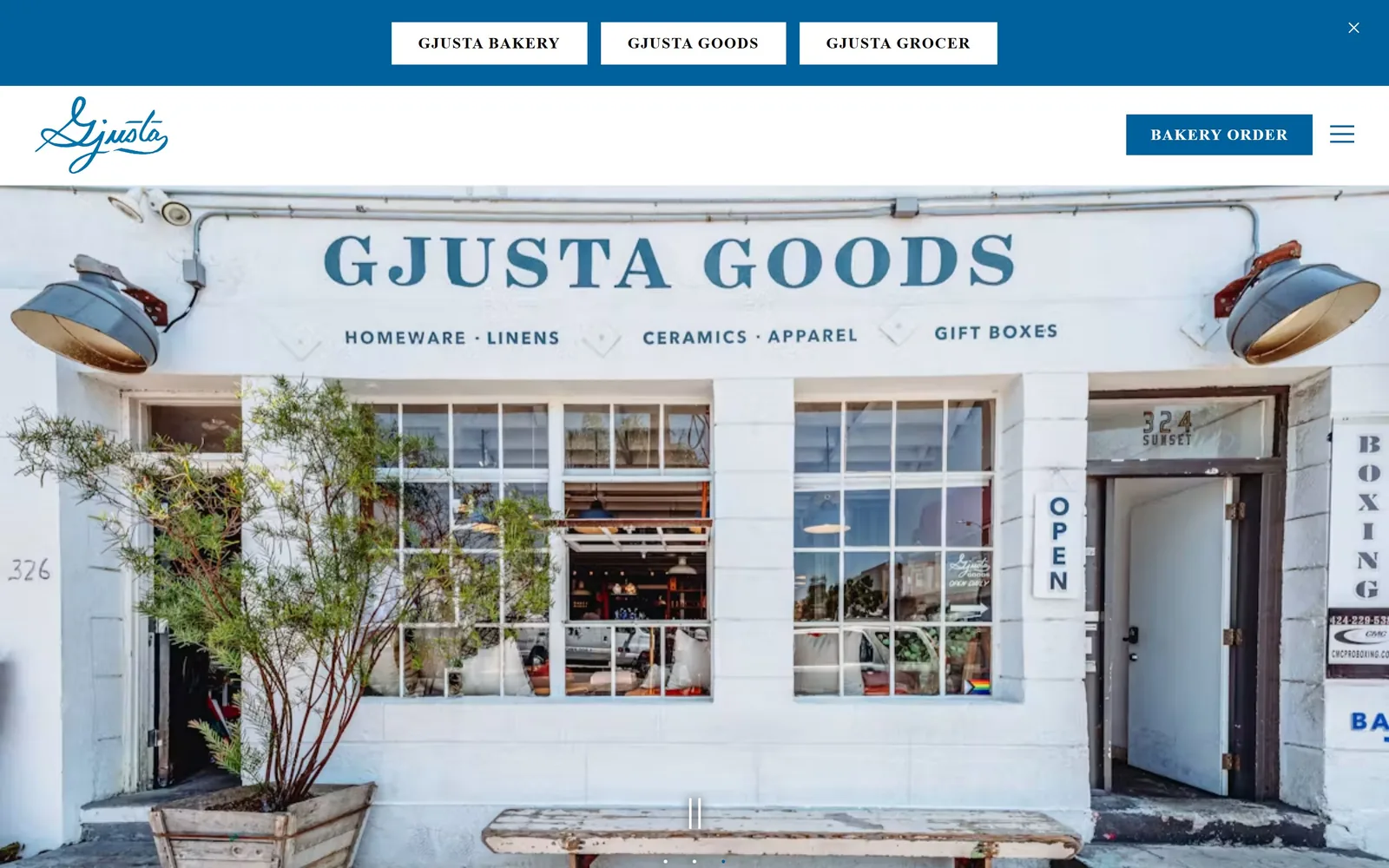 gjusta.com, bakery website design: a blue bar with three white brand chips, a script logo