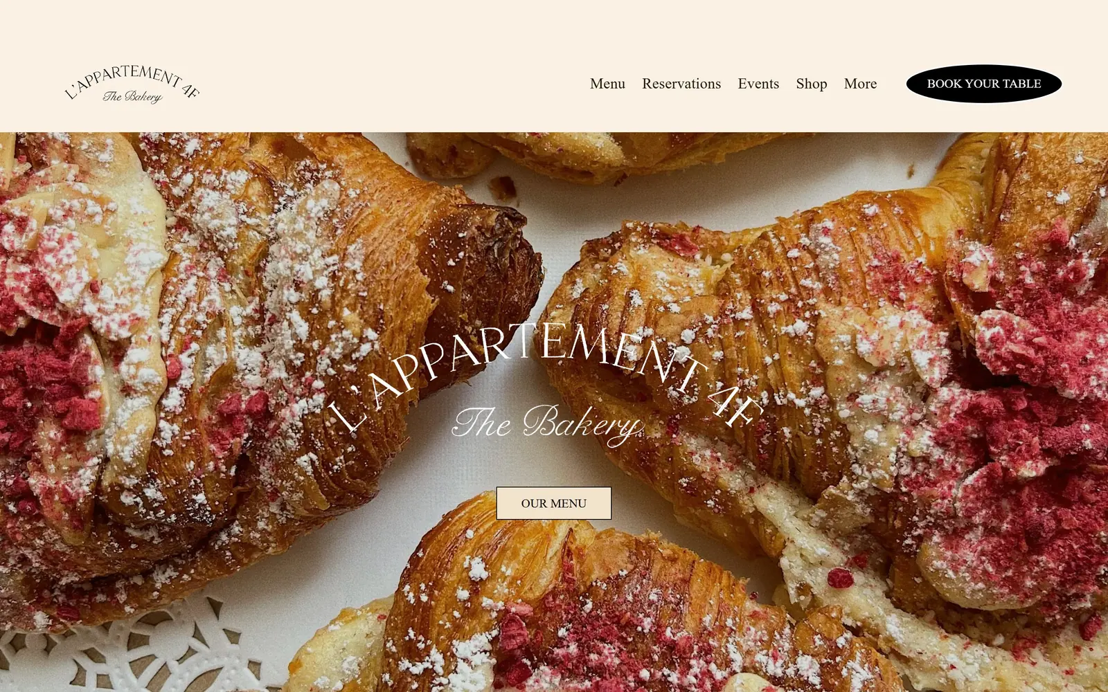 lappartement4f.com, bakery website design: a macro shot of raspberry-dusted croissants with the name arched across it in white and a black