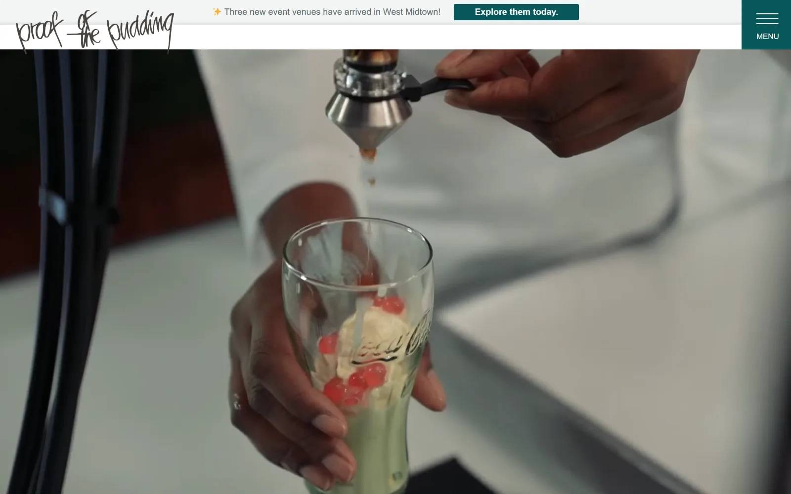 proofpudding.com, catering website design: soft focus fills the frame as a video still of two hands finishing a layered dessert sits
