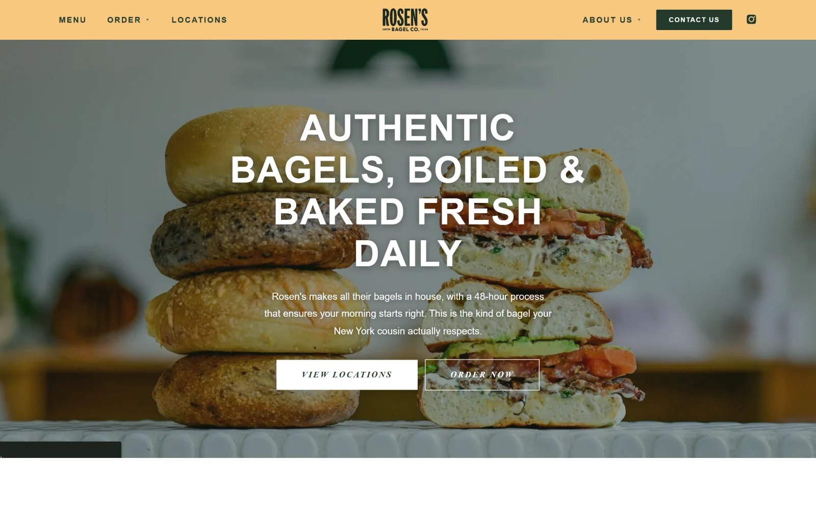 rosensbagels.com, catering website design: centred uppercase type and two small buttons sit over a stack of four bagels and a cut sandwich