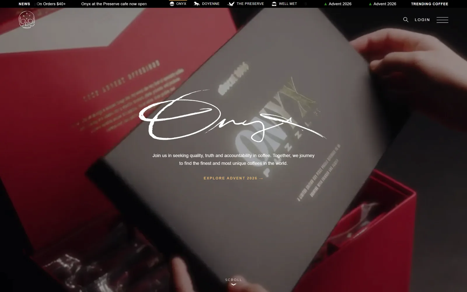 onyxcoffeelab.com, coffee shop website design: dim footage of hands opening a red presentation box sits under a brushed white signature