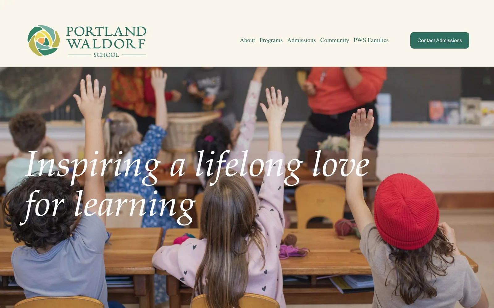 portlandwaldorf.org, daycare website design: children with hands up at wooden desks