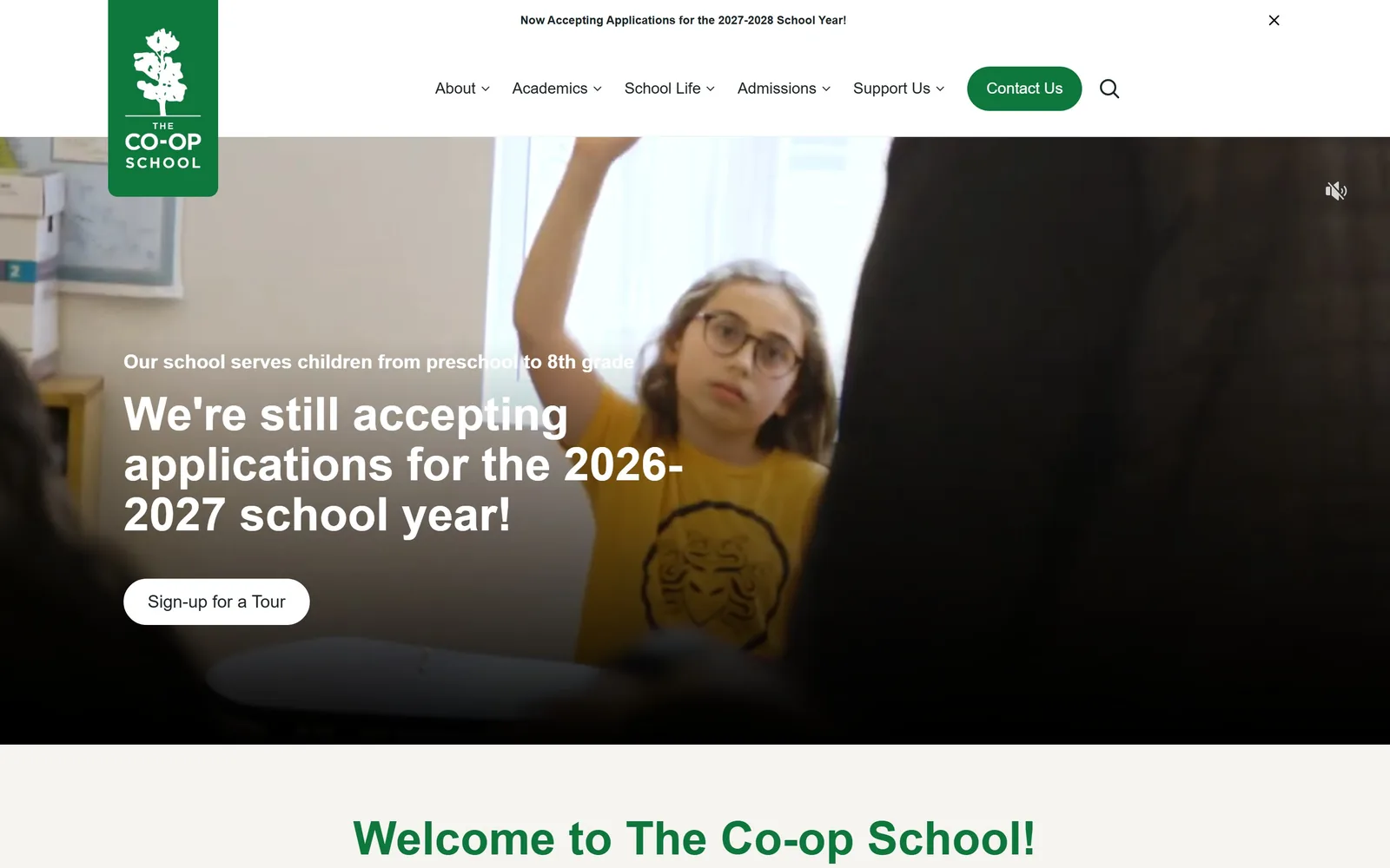 thecoopschool.org, daycare website design: a green flag logo hangs off the top left over a video of a girl raising her hand
