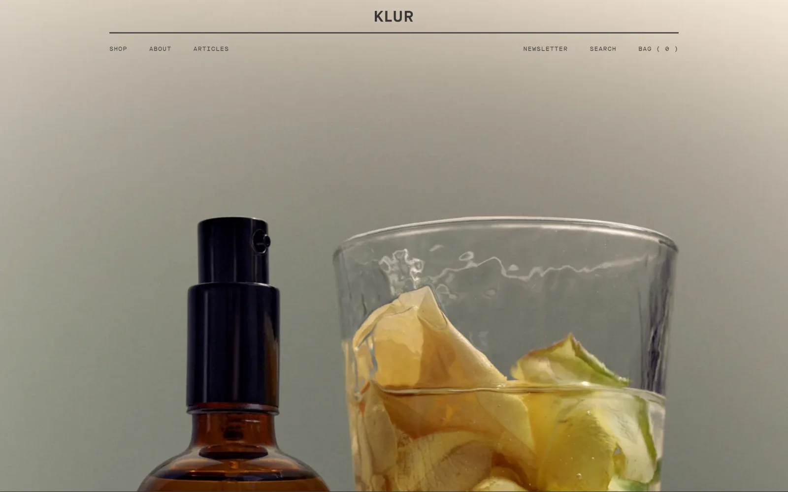 klur.co, ecommerce website design: centred wordmark over a hairline rule and a split nav row