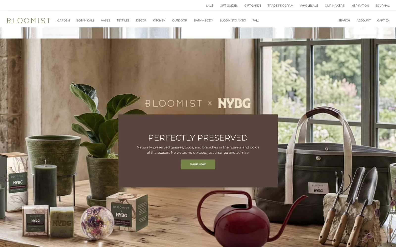 bloomist.com, florist website design: eighteen nav links sit above a table of pots, soaps and a red watering can