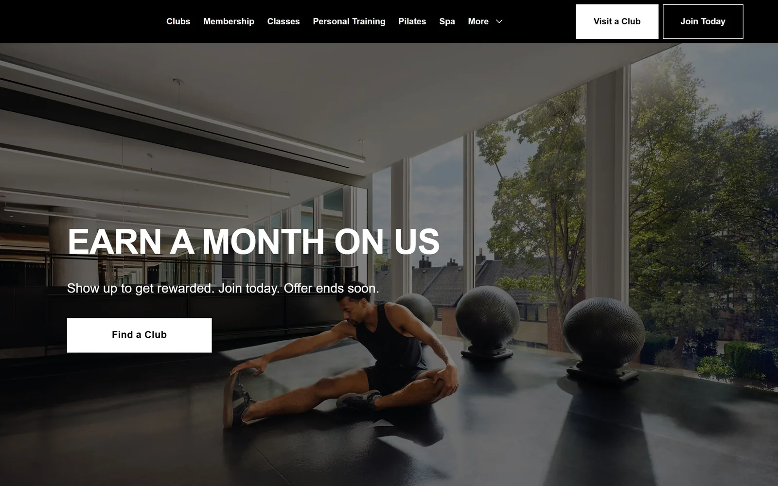 equinox.com, gym website design: black nav bar over a sunlit club floor, 64px white caps headline low on the left