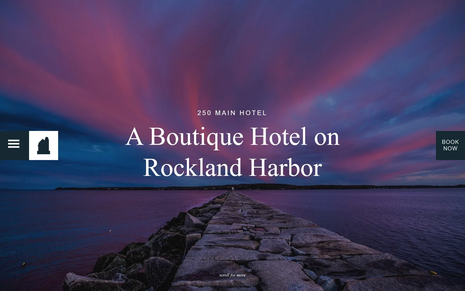 250mainhotel.com, hotel website design: a stone breakwater runs to the horizon under a magenta and blue dusk sky