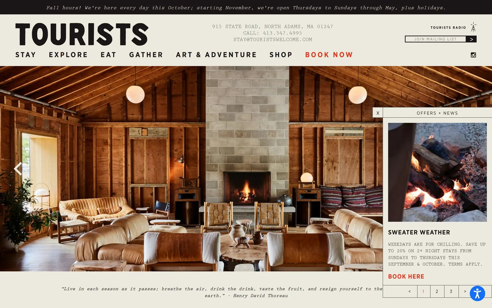 touristswelcome.com, hotel website design: a barn-wood lounge with a lit fireplace under heavy black condensed type and a typewriter-face