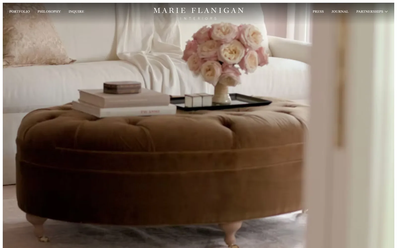 marieflanigan.com, interior design website design: a soft-focus video of a camel velvet ottoman and blush roses