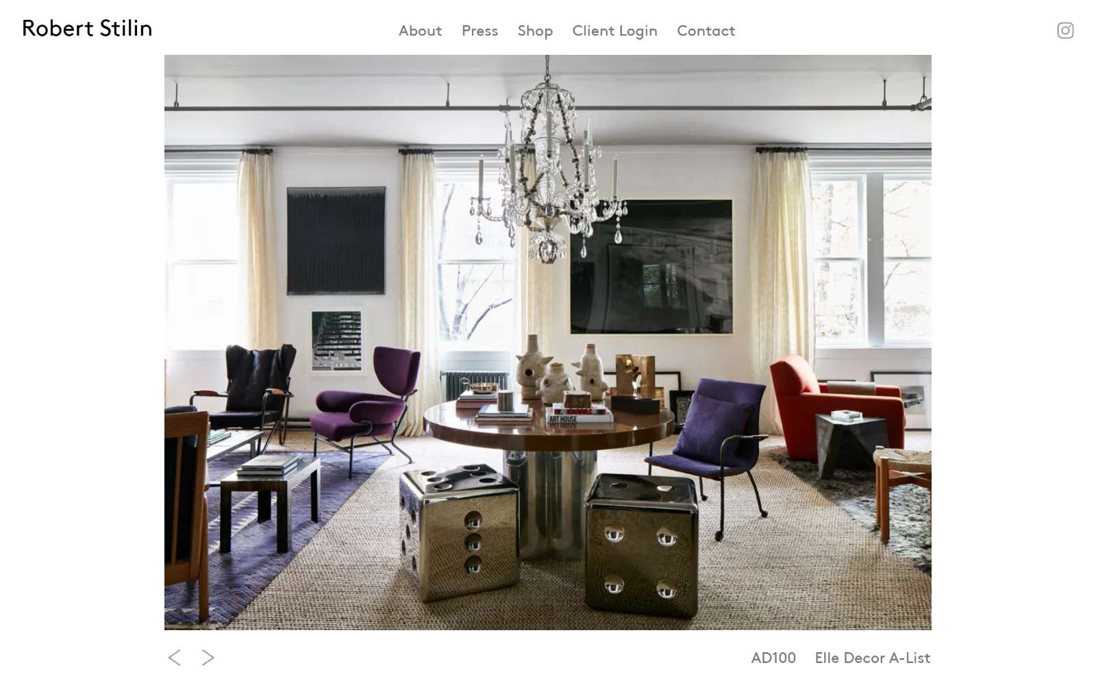 robertstilin.com, interior design website design: a centred, white-framed photograph of a loft with a crystal chandelier