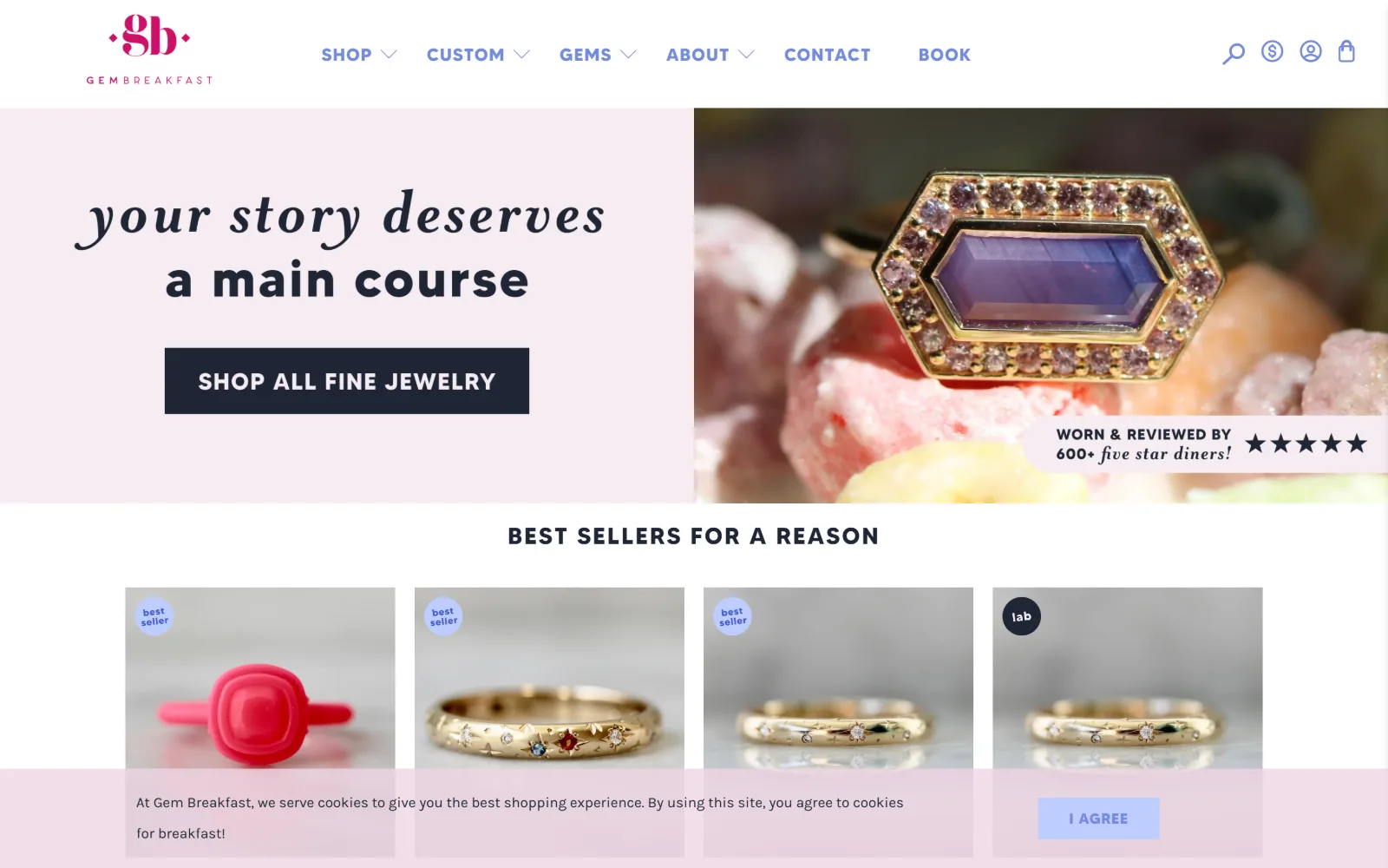 gembreakfast.com, jewelry store website design: script and bold sans headline on a pale pink panel sit left of a ring shot on raw crystals