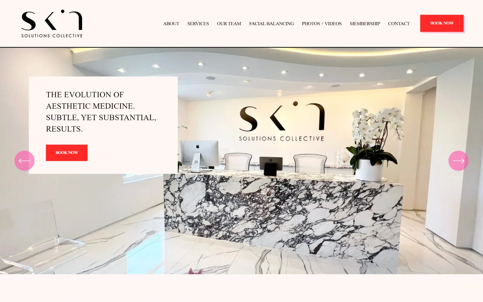 skinsolutions.co, med spa website design: edge to edge, a white reception with a veined marble desk and orchids