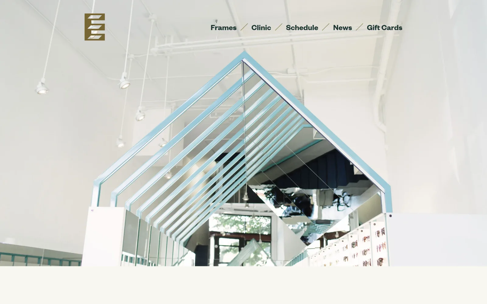 eyeeye.care, optometrist website design: a wide interior shot looking up at a mirrored canopy over the frame displays