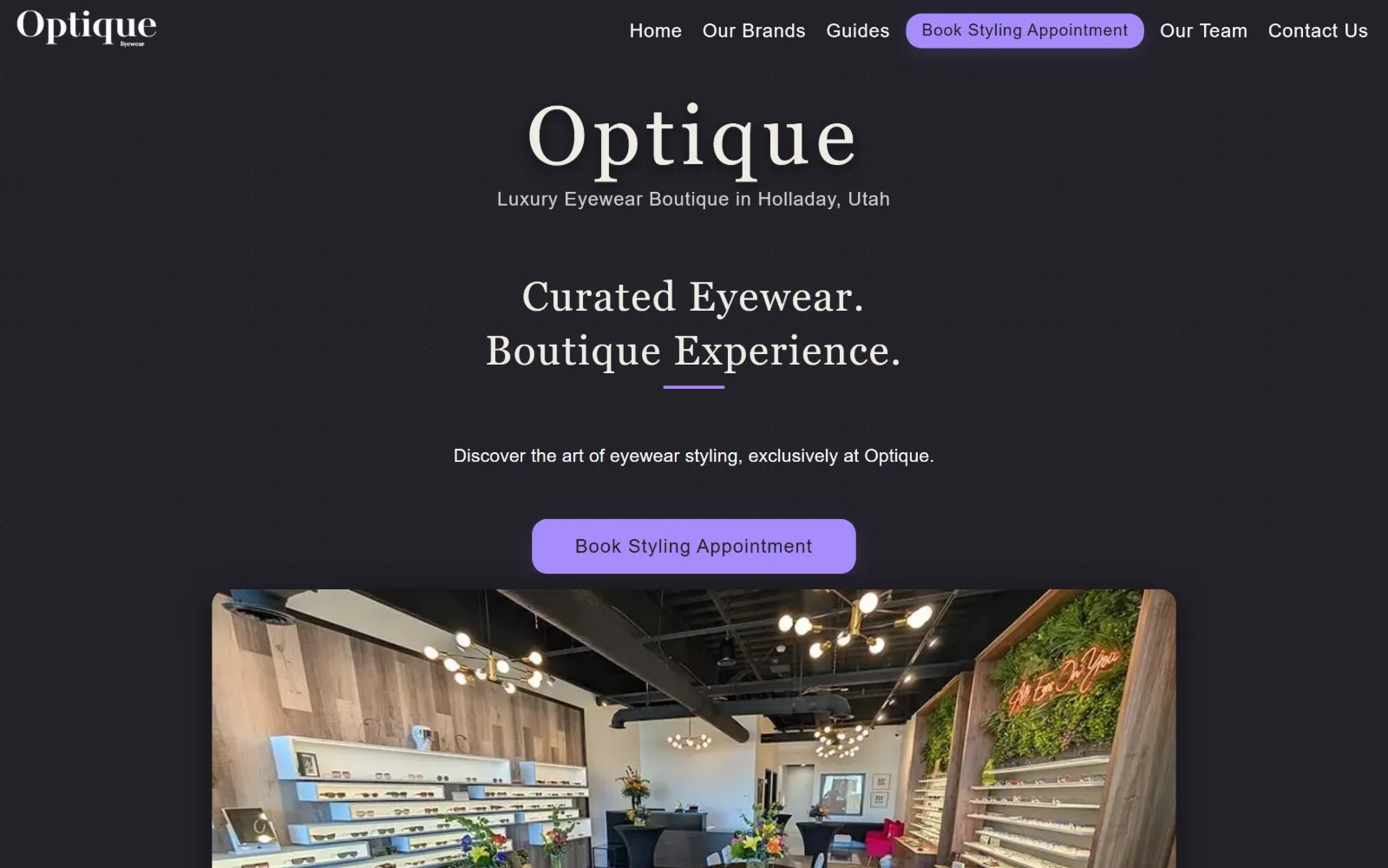 optiqueeyewear.com, optometrist website design: a near-black page with a serif wordmark