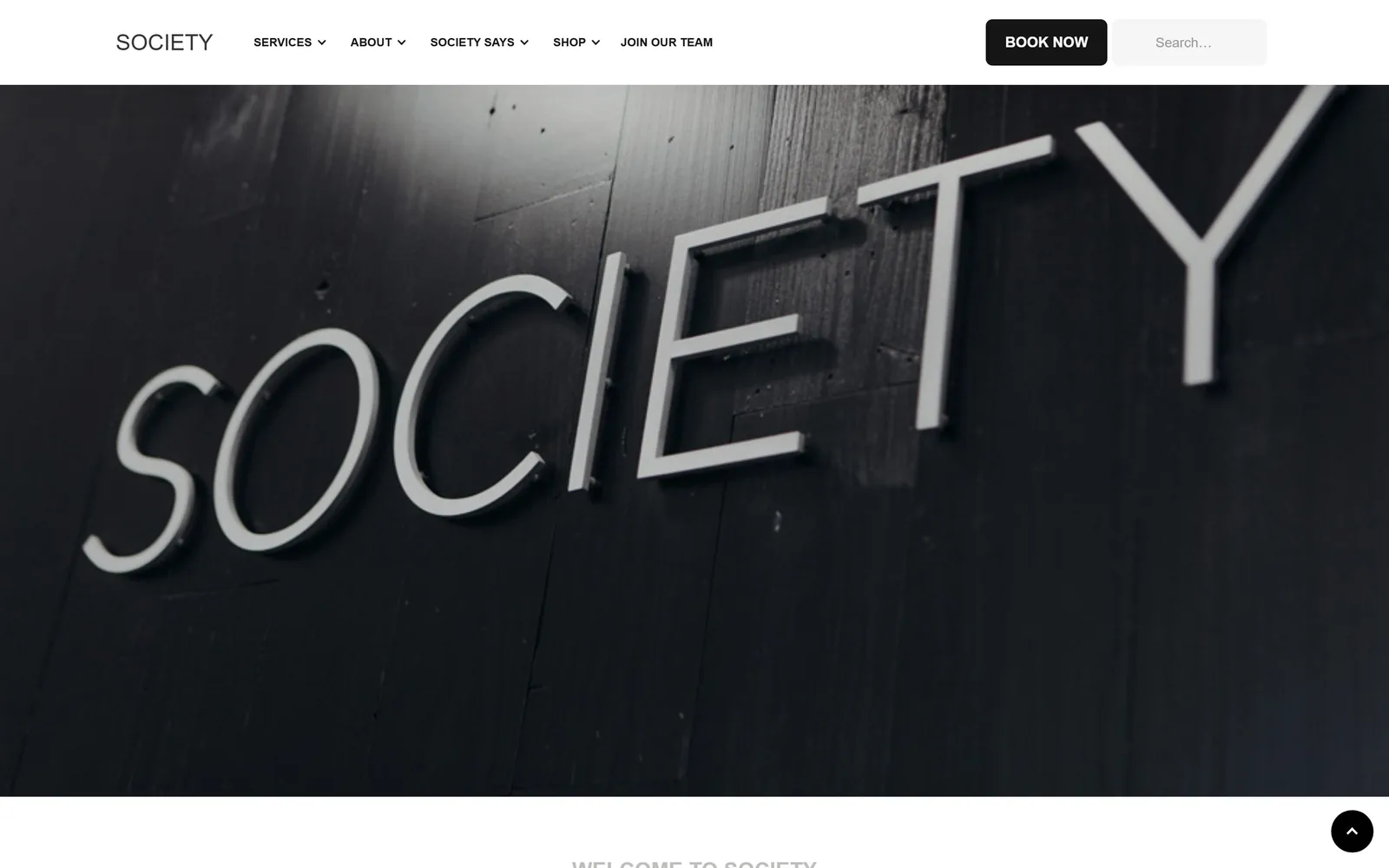 societysalons.com, salon website design: a close black-and-white photograph of the salon's own SOCIETY signage