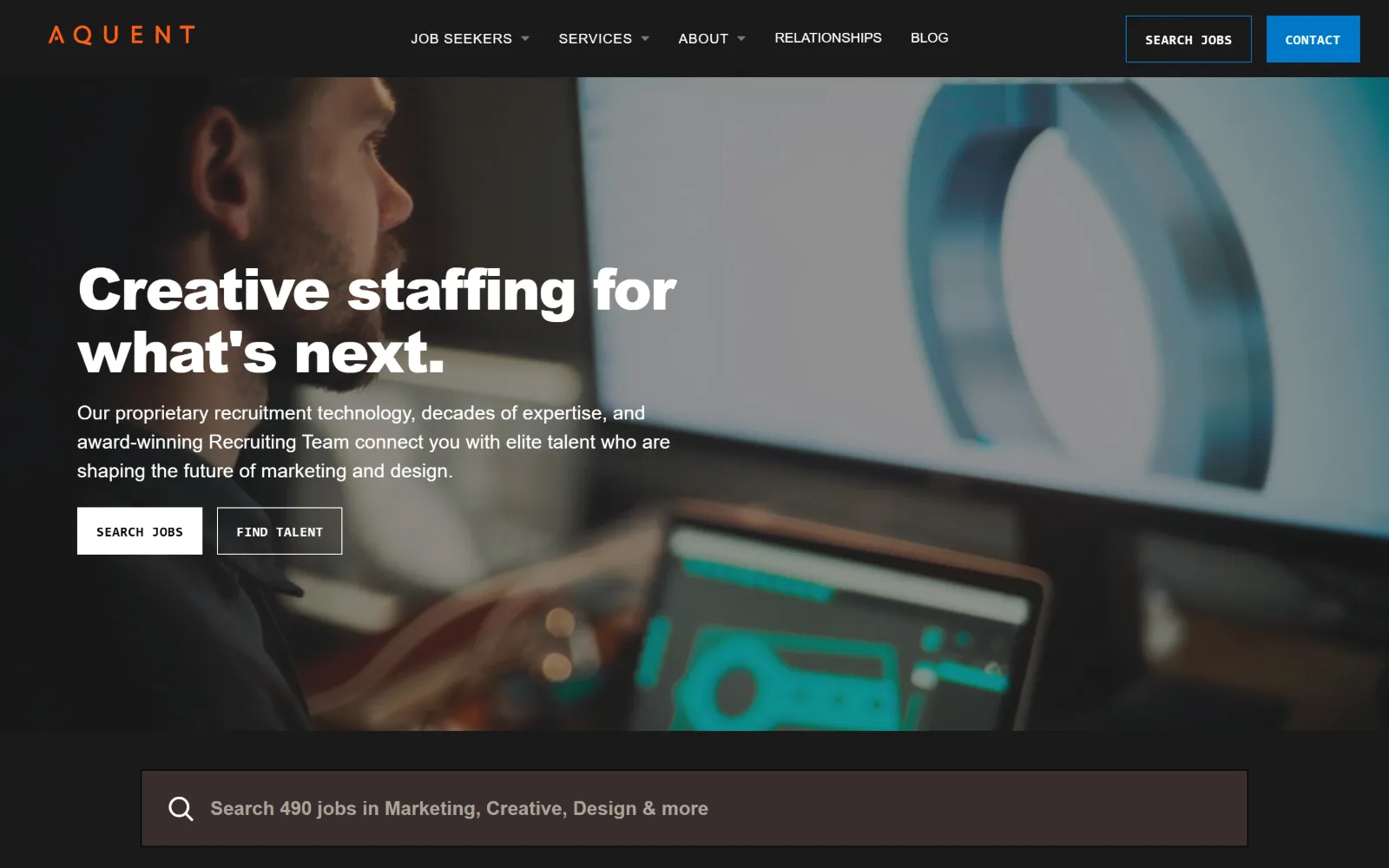 aquent.com, staffing agency website design: dark photograph of a designer at a monitor behind a black header