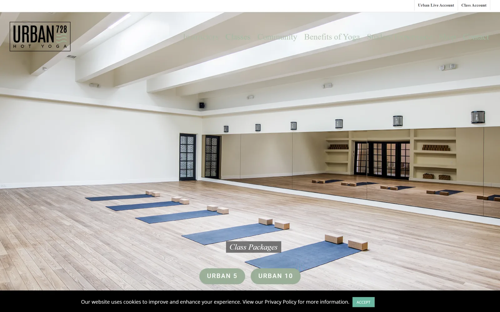 urban728yoga.com, yoga studio website design: a mirrored room with five blue mats on pale oak