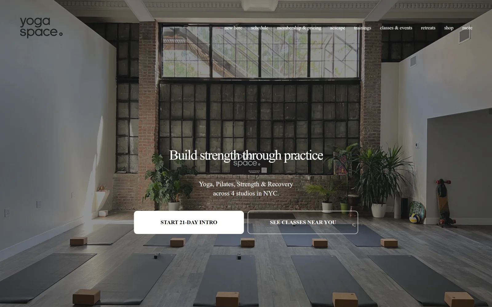 yogaspace.nyc, yoga studio website design: mats and cork blocks line up across a loft floor under a tall factory window